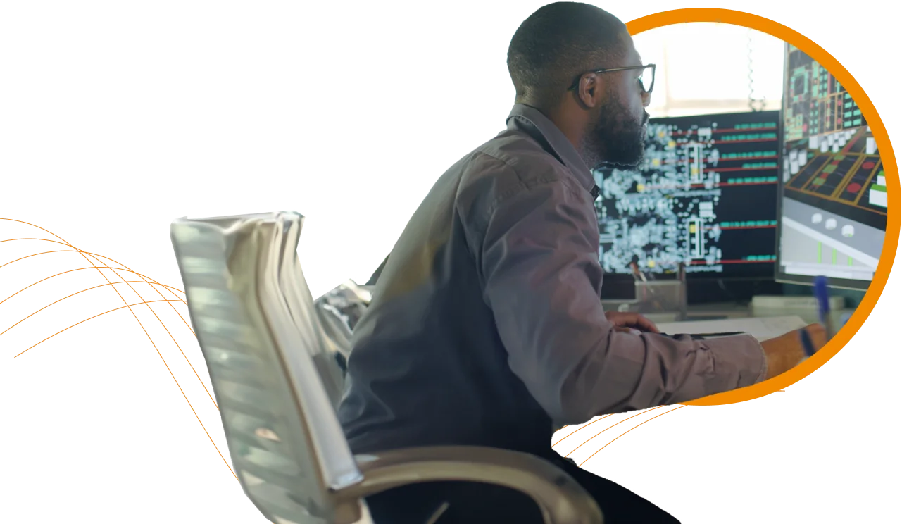 A man at a desk with a computer monitor, representing Pharma Access's expertise in innovative healthcare solutions.